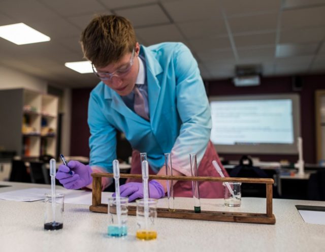 A pupil carrying out a science experiment