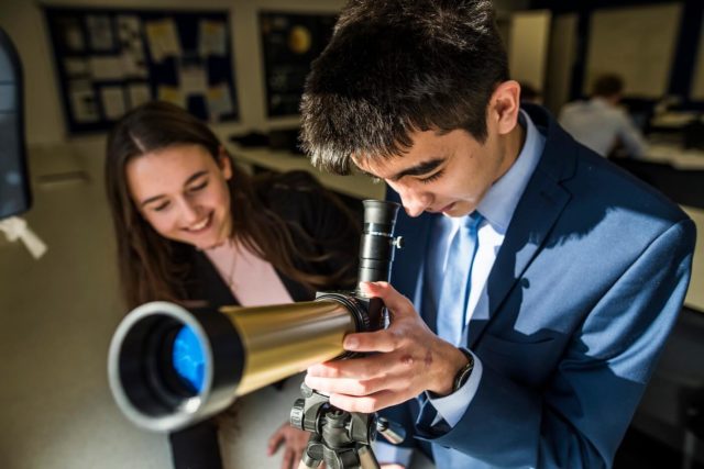 Sixth Form students looking through a telescope
