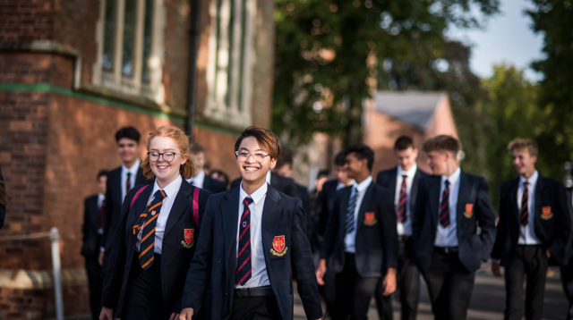 a group of trent college senior pupils walking across the campus