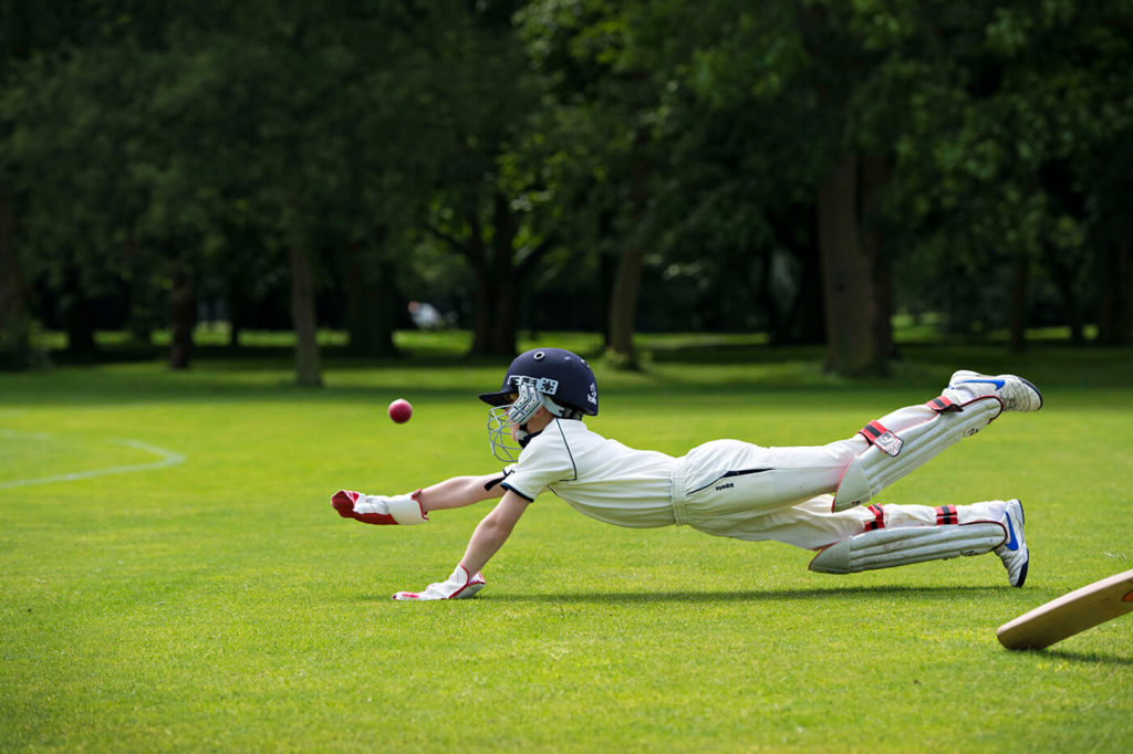 A Trent College pupil playing cricket in the school grounds