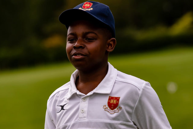 A pupil looking happy playing Cricket at Trent College