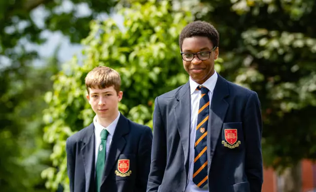 Two school boys walking side by side