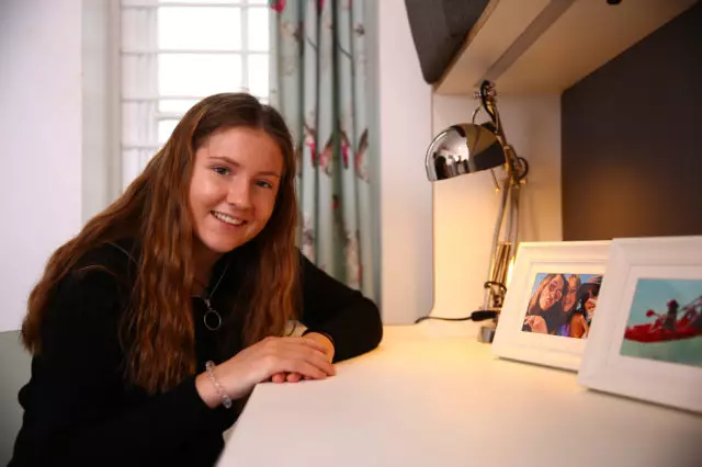 trent college boarding room with young female student sat at her desk