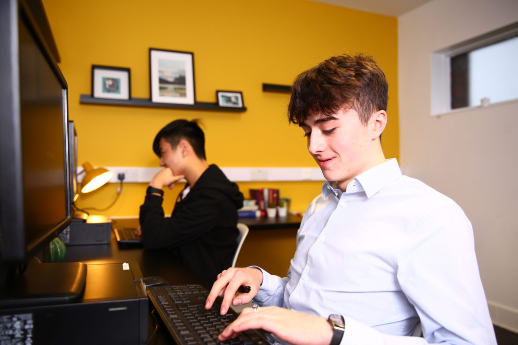 Two Sixth Form boarders studying in their boarding house