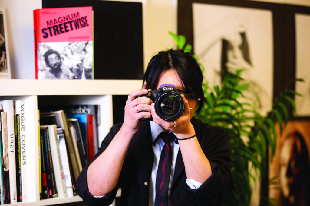 Girl holding a camera in front of her face.