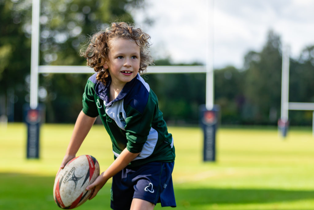 Young boy playing rugby