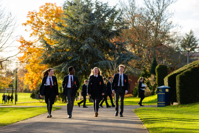 A group of boys and girls walking in the Trent College grounds.