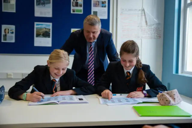 Teacher with two girl pupils