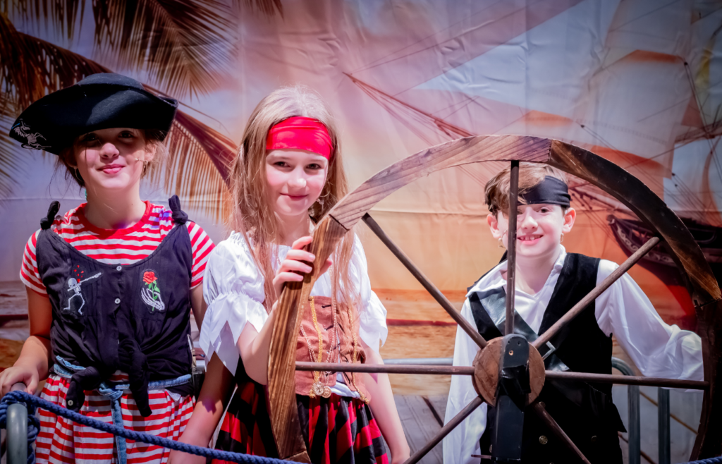 Three pupils dressed as pirates before their show on the stage.